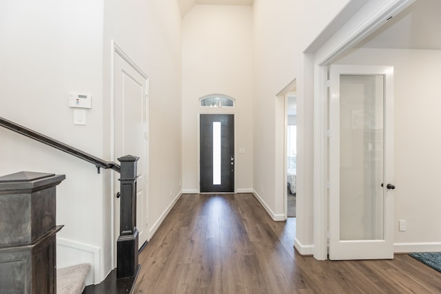 foyer featuring hardwood / wood-style floors and a high ceiling