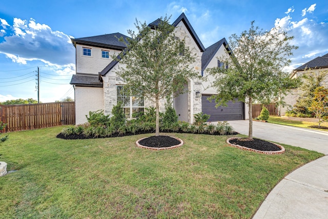 view of front of house with a front yard and a garage