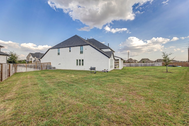 rear view of property with a lawn