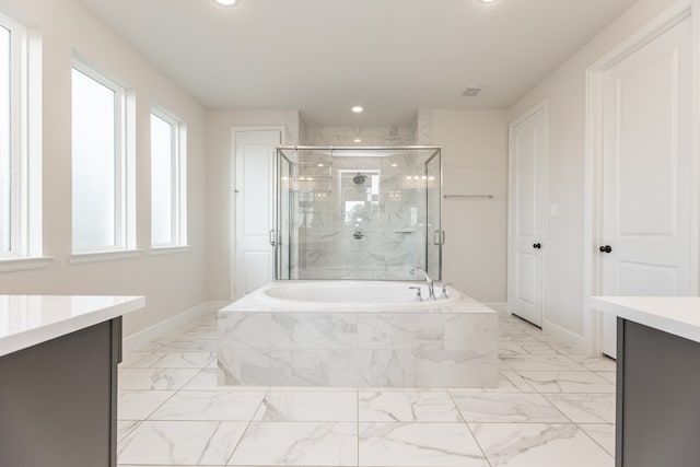 bathroom with vanity and independent shower and bath