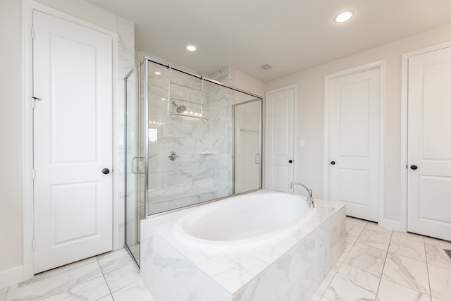 bathroom featuring independent shower and bath