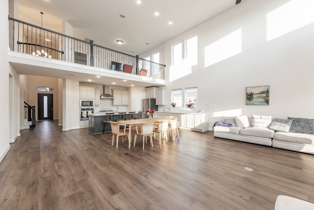 dining room with a high ceiling and wood-type flooring