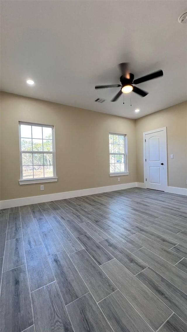 empty room with dark hardwood / wood-style flooring and ceiling fan