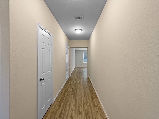 hall with hardwood / wood-style floors