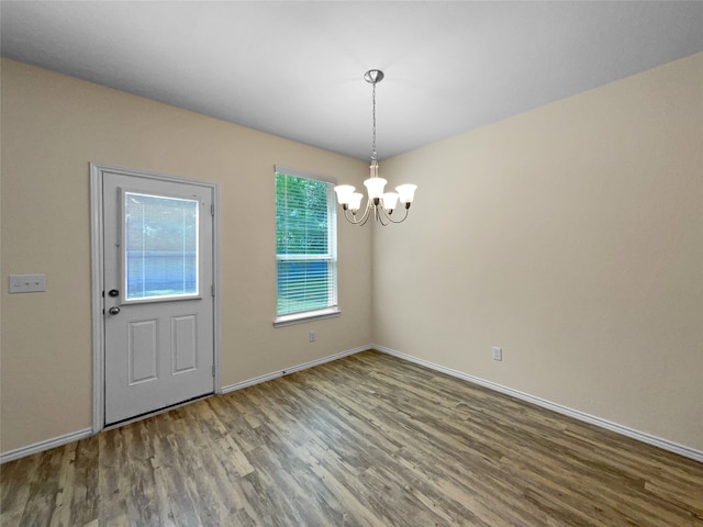 interior space featuring wood-type flooring and a notable chandelier