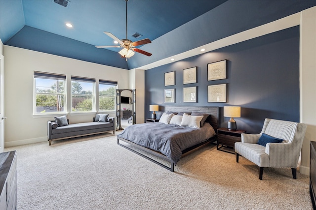 carpeted bedroom with ceiling fan and high vaulted ceiling