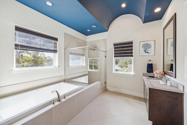 bathroom featuring independent shower and bath, tile patterned flooring, and vanity