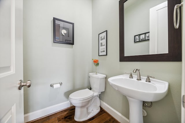 bathroom with wood-type flooring and toilet