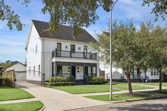 view of front of property featuring a balcony, a front yard, and a porch