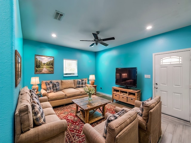 living room featuring light hardwood / wood-style floors and ceiling fan