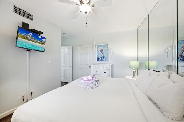 bedroom featuring ceiling fan and dark hardwood / wood-style floors