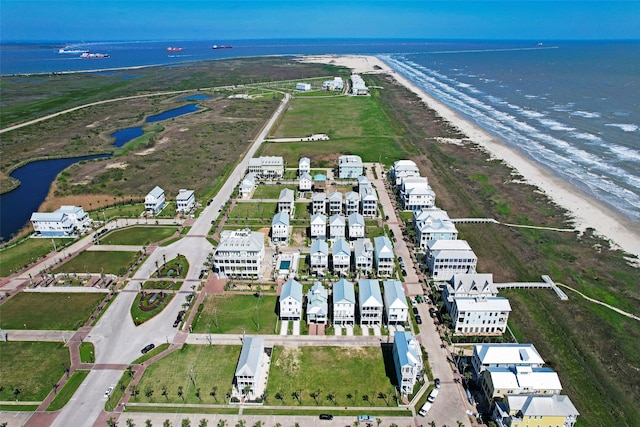 birds eye view of property with a view of the beach and a water view