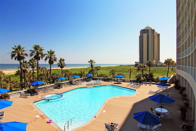 view of swimming pool with a water view and a patio area