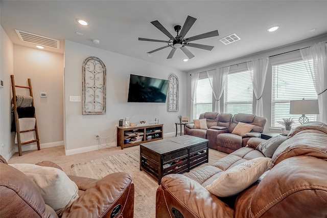 living room featuring ceiling fan and light colored carpet