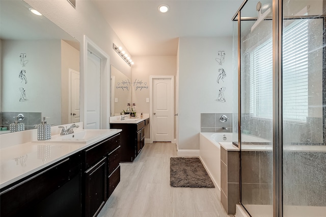 bathroom featuring vanity, plus walk in shower, and hardwood / wood-style flooring