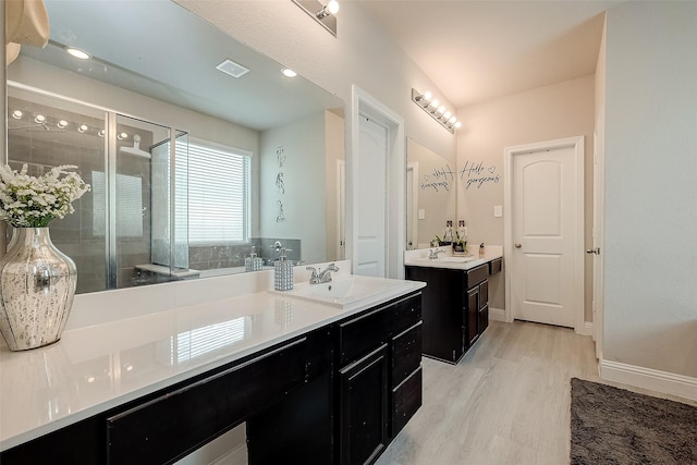 4731 Seabourne Landing Dr, Rosenberg, TX 77469 - full bath featuring a shower stall, wood finished floors, two vanities, and baseboards