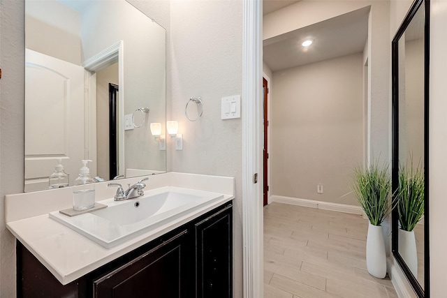 4731 Seabourne Landing Dr, Rosenberg, TX 77469 - bathroom with wood finished floors, baseboards, vanity, and recessed lighting