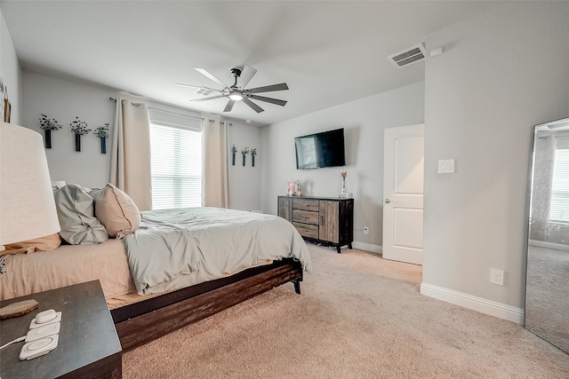 bedroom with light carpet and ceiling fan