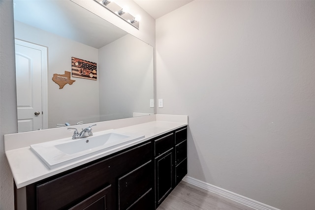 bathroom with hardwood / wood-style flooring and vanity