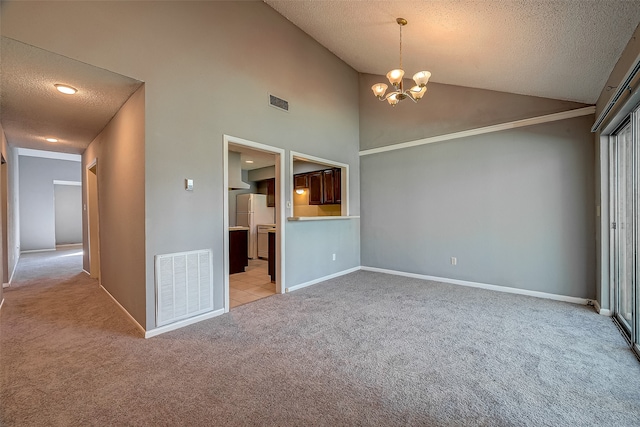 interior space with a textured ceiling, a notable chandelier, and high vaulted ceiling