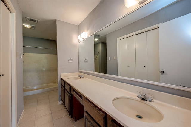 bathroom featuring walk in shower, vanity, and tile patterned floors