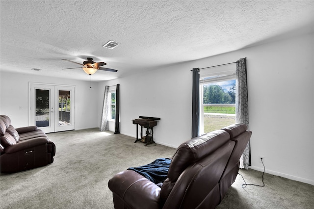 living room with ceiling fan, french doors, carpet, and a wealth of natural light