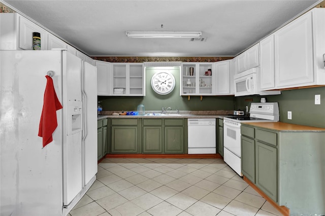 kitchen with light tile patterned floors, sink, white appliances, white cabinetry, and green cabinets