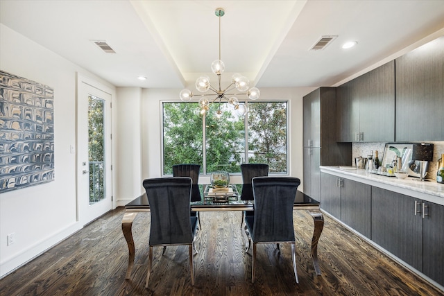 dining space with a notable chandelier, dark hardwood / wood-style flooring, and plenty of natural light