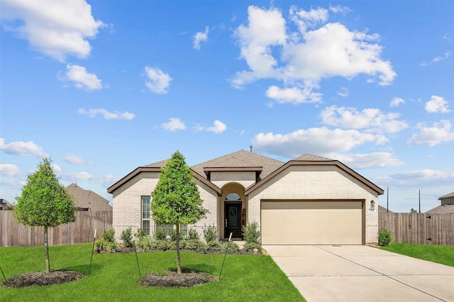 view of front of home with a front lawn and a garage