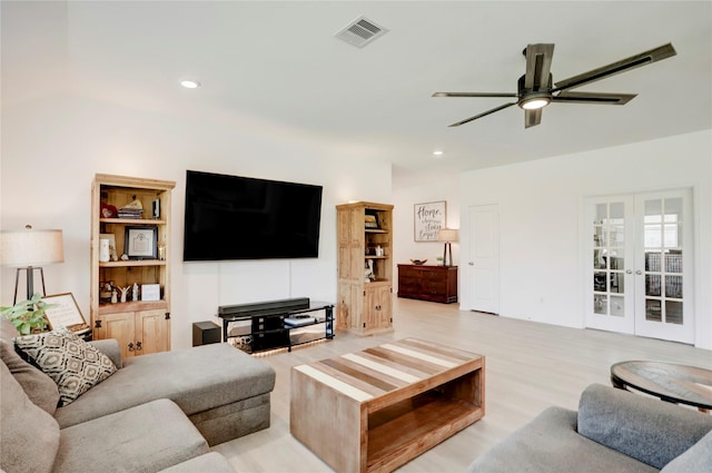 living room with ceiling fan, light hardwood / wood-style flooring, and french doors