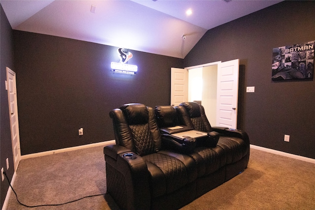 home theater room featuring vaulted ceiling and carpet flooring