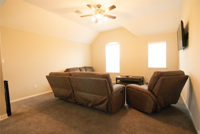 home theater featuring dark colored carpet, lofted ceiling, and ceiling fan