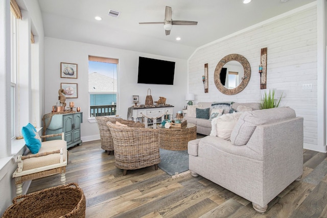 living room featuring vaulted ceiling, ceiling fan, and dark wood-type flooring