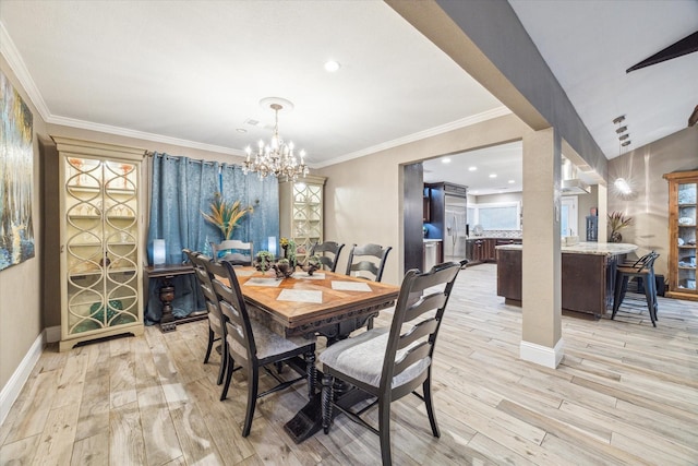 dining room with a chandelier, ornamental molding, baseboards, and light wood-style floors