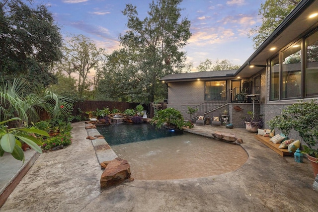 view of swimming pool featuring a fenced in pool, a fenced backyard, a patio, and stairs