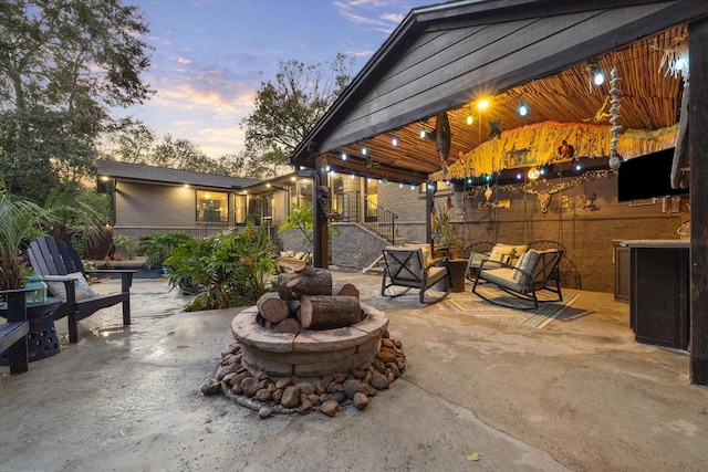 view of patio / terrace with an outdoor living space with a fire pit