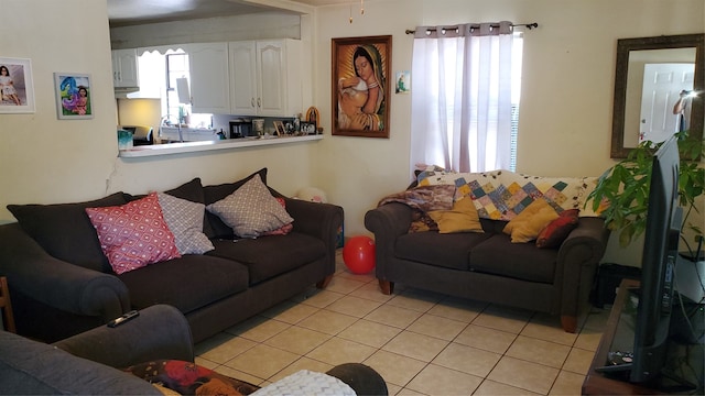 tiled living room featuring sink