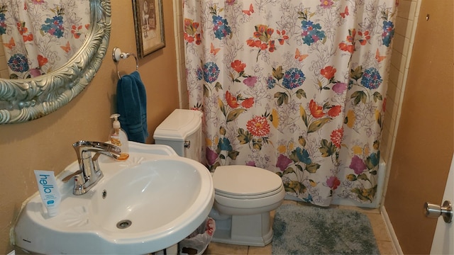 bathroom with tile patterned flooring, toilet, and sink