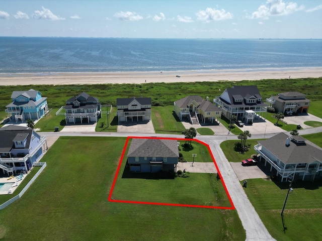 drone / aerial view featuring a water view and a view of the beach