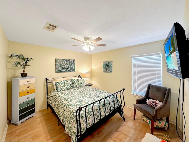 bedroom with ceiling fan and hardwood / wood-style flooring