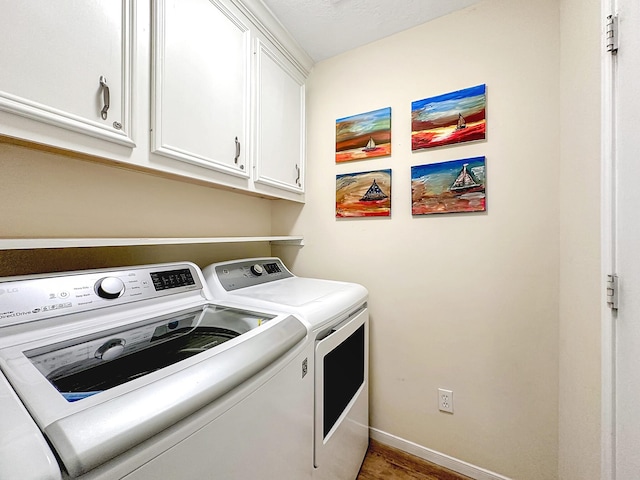 laundry room featuring cabinets, dark wood-type flooring, and independent washer and dryer