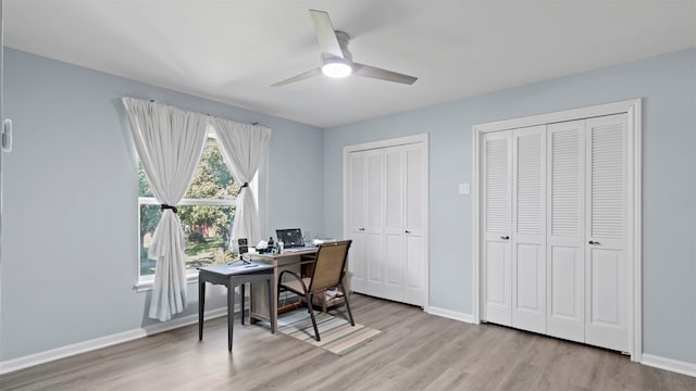 office area with light wood-type flooring and ceiling fan