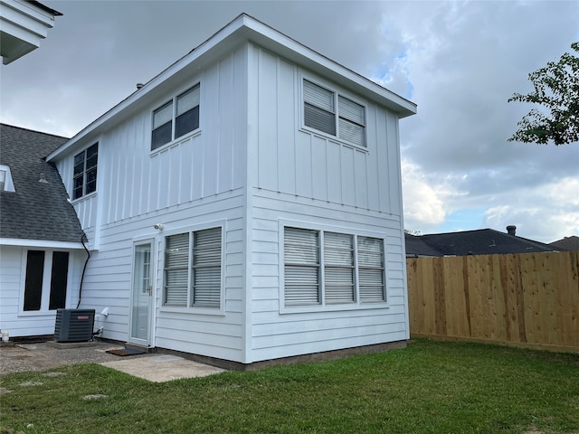 exterior space featuring a yard and central AC