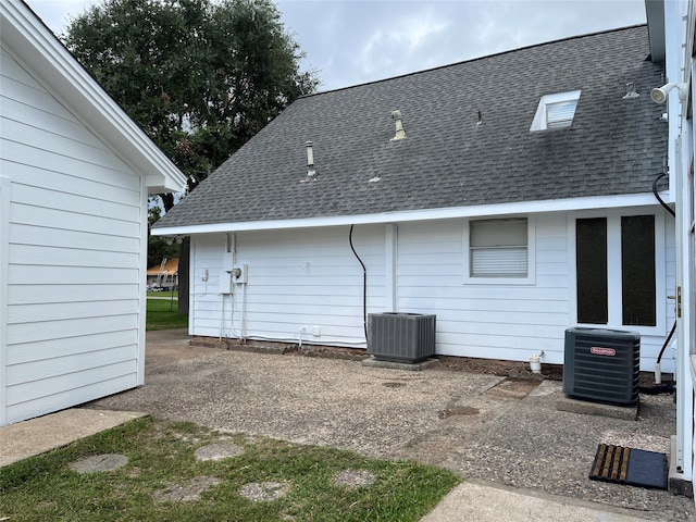 rear view of house featuring central AC unit