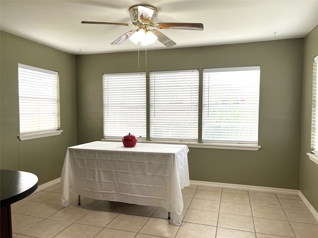 bedroom featuring multiple windows, light tile patterned flooring, and ceiling fan