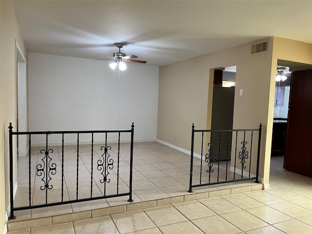 unfurnished room featuring ceiling fan and light tile patterned floors