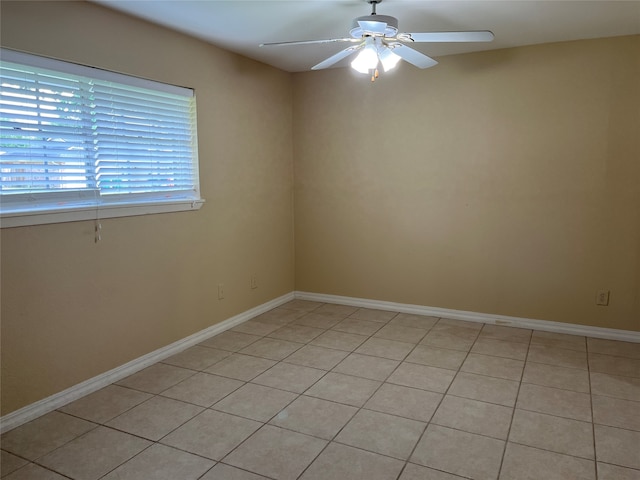 tiled spare room with ceiling fan