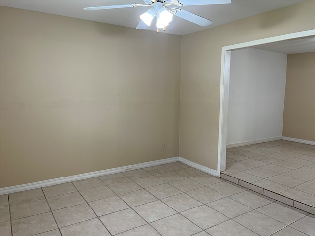 spare room featuring ceiling fan and light tile patterned floors