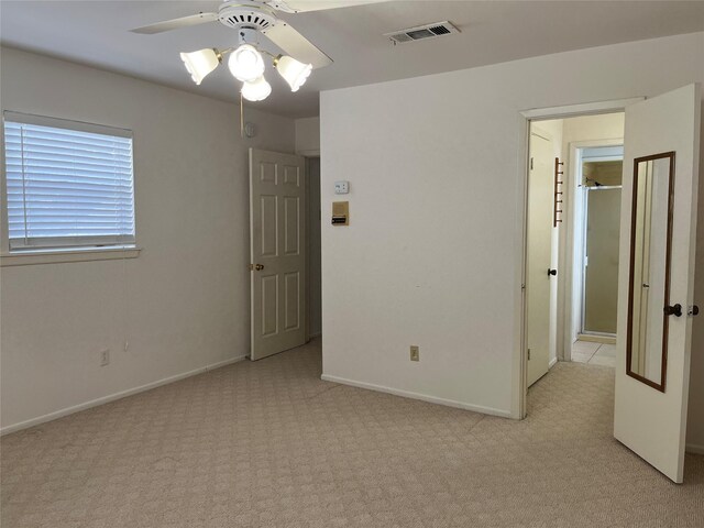 spare room with light carpet and ceiling fan