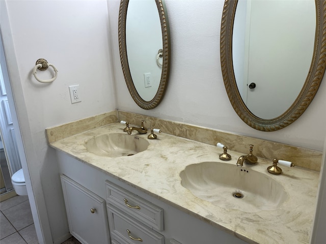 bathroom featuring vanity, toilet, and tile patterned floors